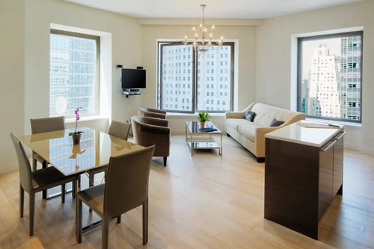 Bright open-plan apartment living and dining area kept clean by a professional service