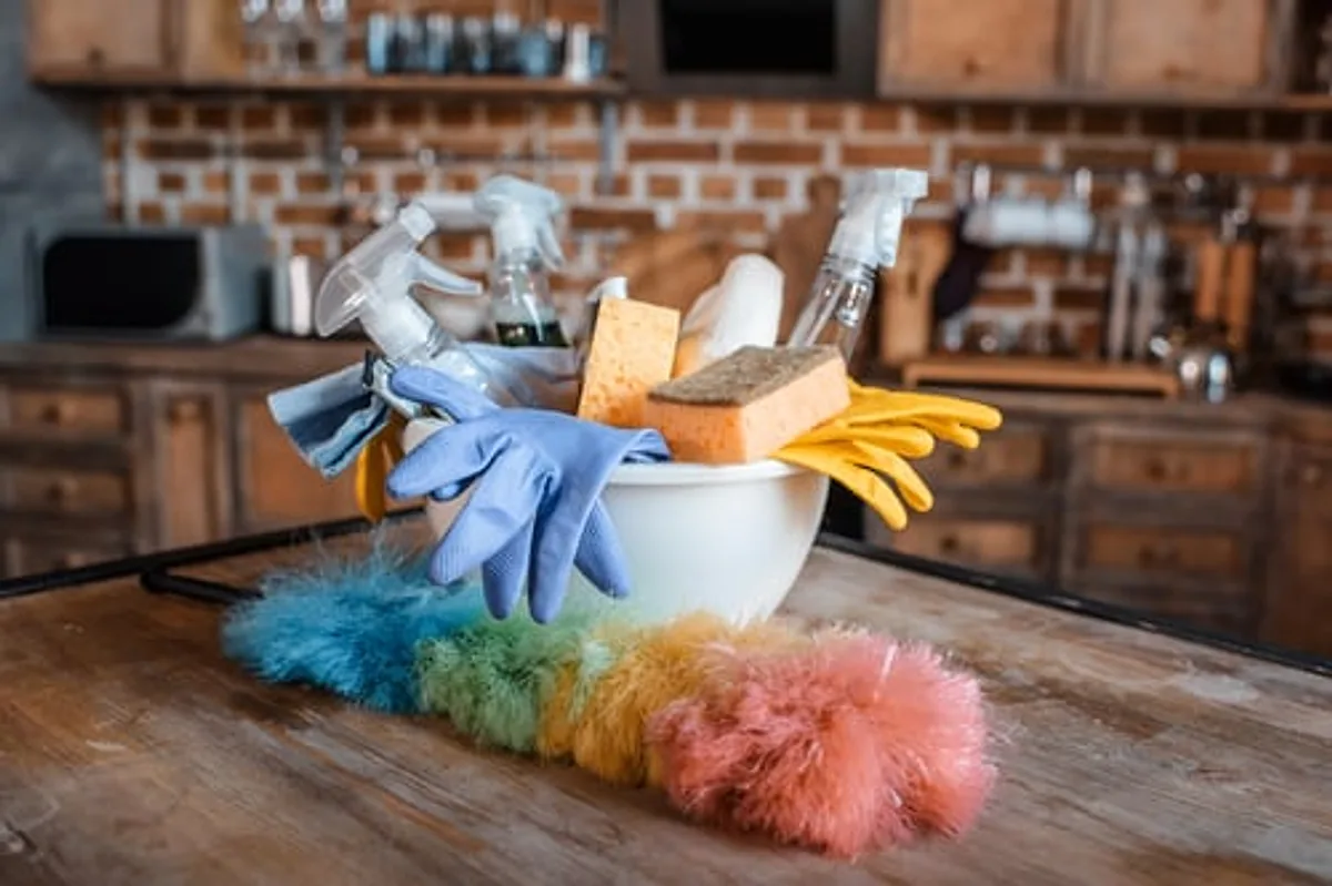 Assorted professional cleaning supplies and dusters ready for a general cleaning job