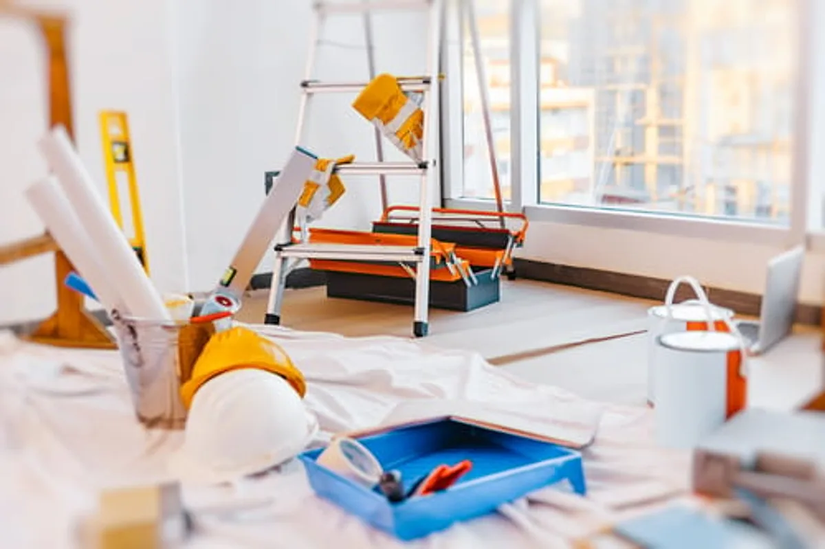 Interior renovation site with tools and materials awaiting post-construction cleaning